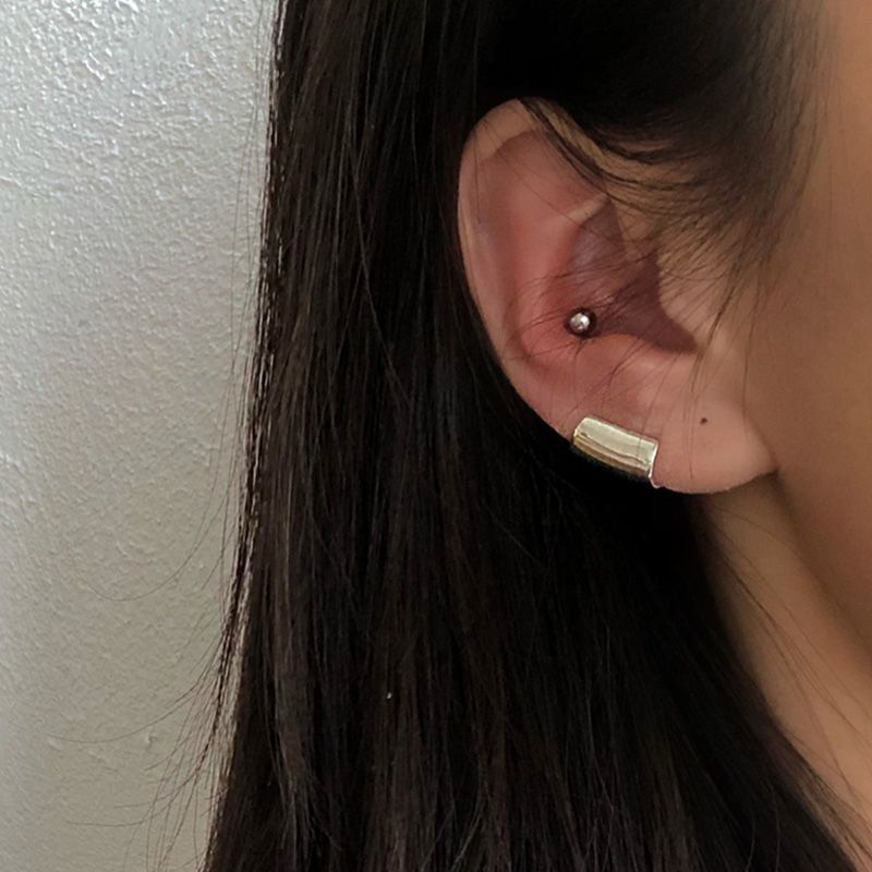Sterling silver ear cuff with a sleek cylinder design. No piercing needed—lightweight, modern, and effortlessly stylish.