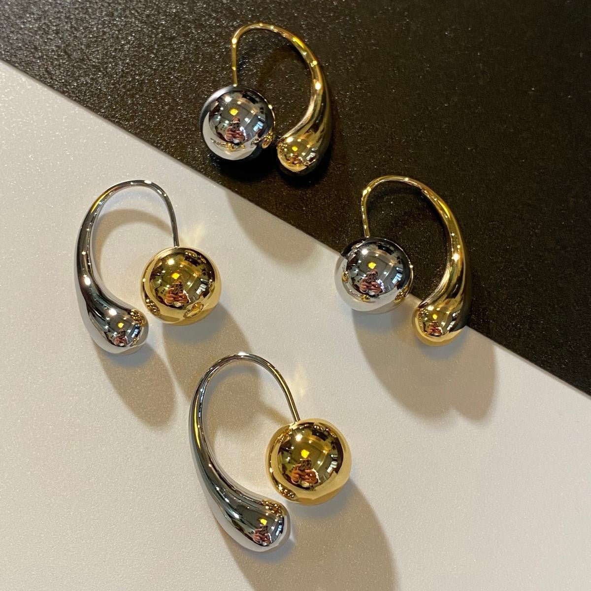 Two toned drop earrings in gold and silver with a bold mixed-metal design for a statement look.