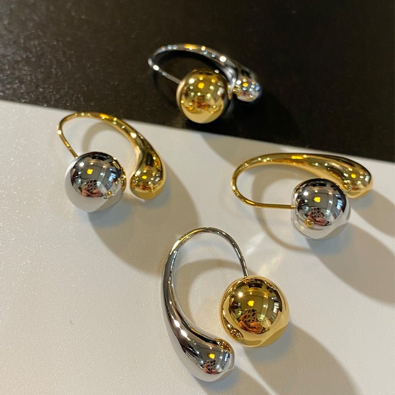 Two-toned hoop earrings in gold and silver with a bold mixed-metal design for a statement look.
