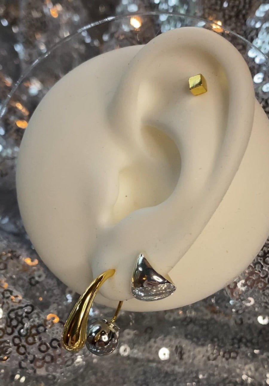 Two-toned earrings in gold and silver with a bold mixed-metal design for a statement look.