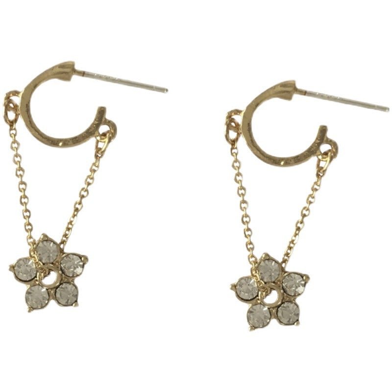 Gold hoop earrings with delicate flower charms and semi-precious stones for a feminine and elegant look.