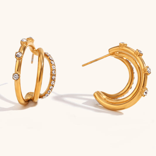 Gold Triple Hoop Earrings Inlaid with Zircon Stones. The unique C-shaped design and dazzling Zircon inlay give you a multiple earring look without the commitment of extra piercings